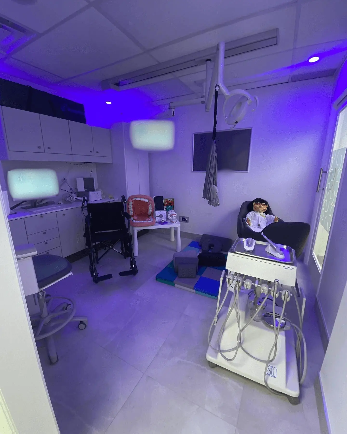 UBCS | A dental office interior with a treatment chair, television, and computer, optimized for dental clinic services and patient comfort.